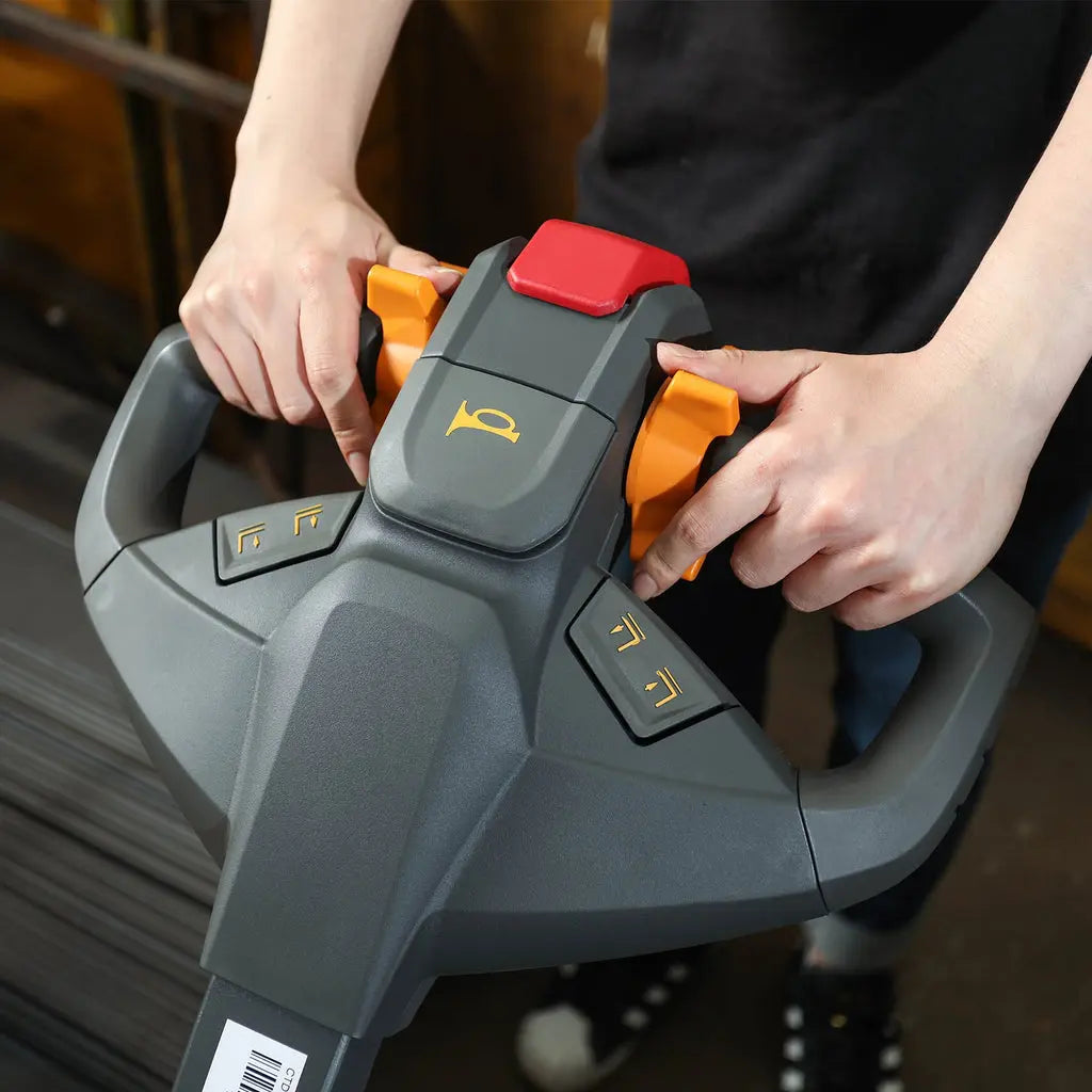 a man holding the electric straddle stacker handle