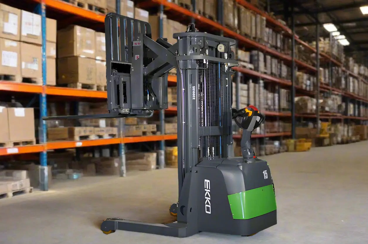 Walkie reach truckwith extended forks parked in warehouse aisle with shelves.