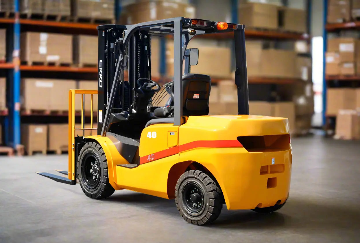 Yellow forklift with red stripe parked in warehouse with stacked boxes.