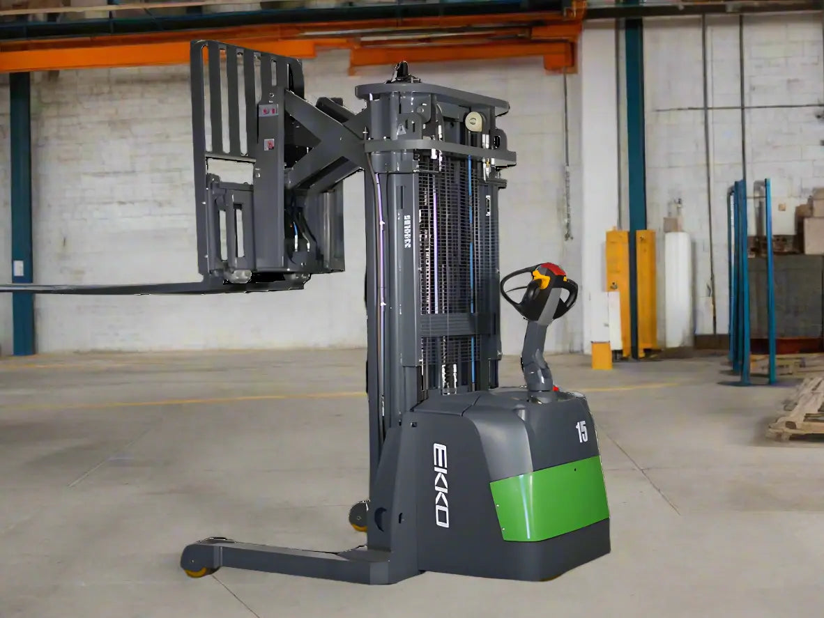 walkie reach truck with extended forks parked in warehouse aisle with shelves.