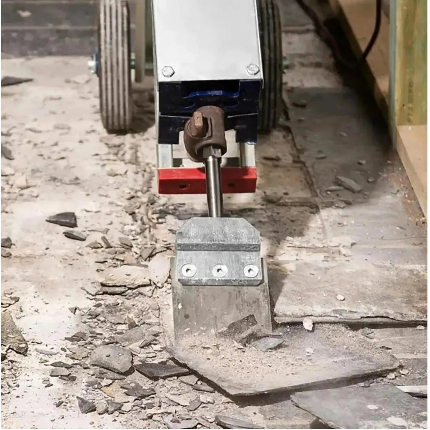 Makinex floor cleaning tool in action, removing tiles and debris from a surface.