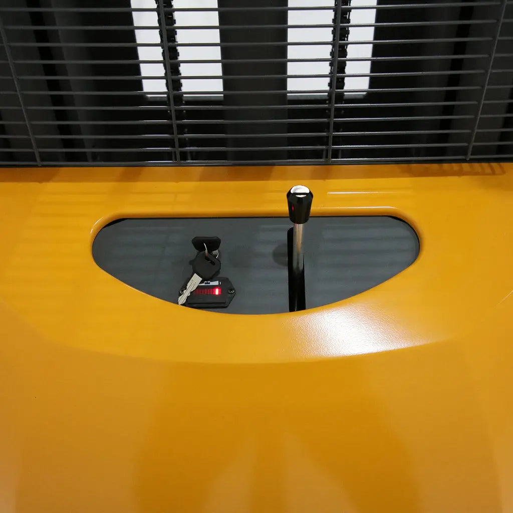 Close-up of key ignition and control lever on yellow Apollolift A-3011 straddle stacker