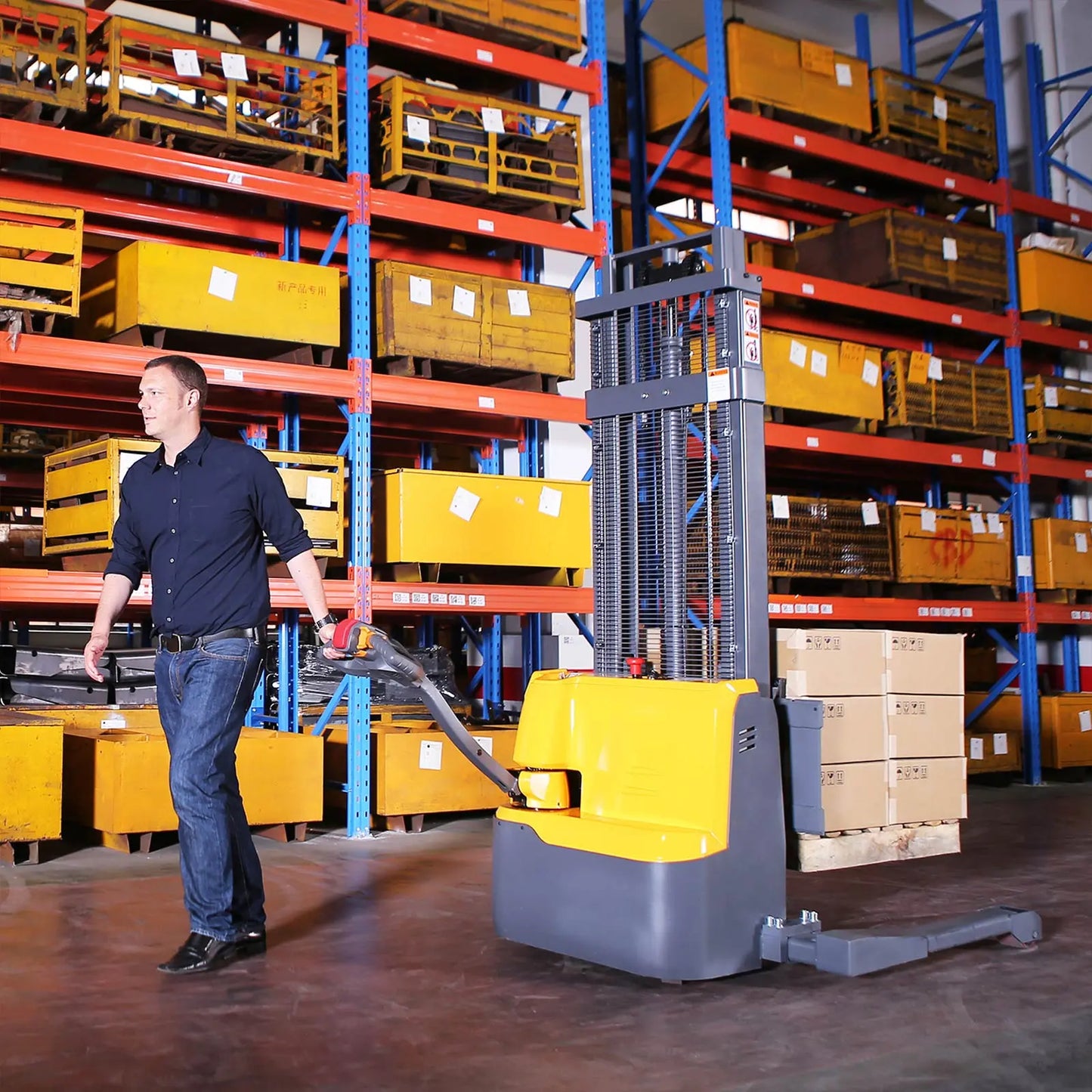 Apollolift A-3022 straddle stacker lifting pallets in a warehouse with a man operating it