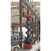 Ballymore drivable compact scissor lift elevated in an industrial warehouse with worker on platform