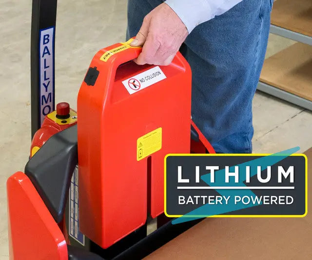 Person handling lithium battery pack for a powered pallet jack.