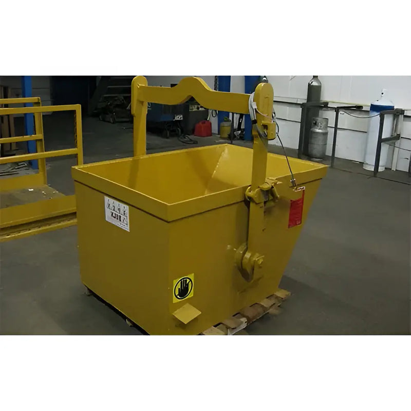 Yellow steel hopper with lifting handle placed indoors on a pallet.