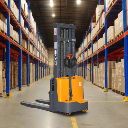 Orange and gray electric stacker forklift in warehouse with tall shelves.