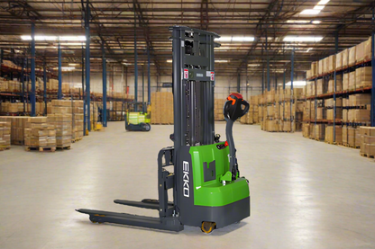 Green EKKO electric stacker in a large warehouse with equipment.