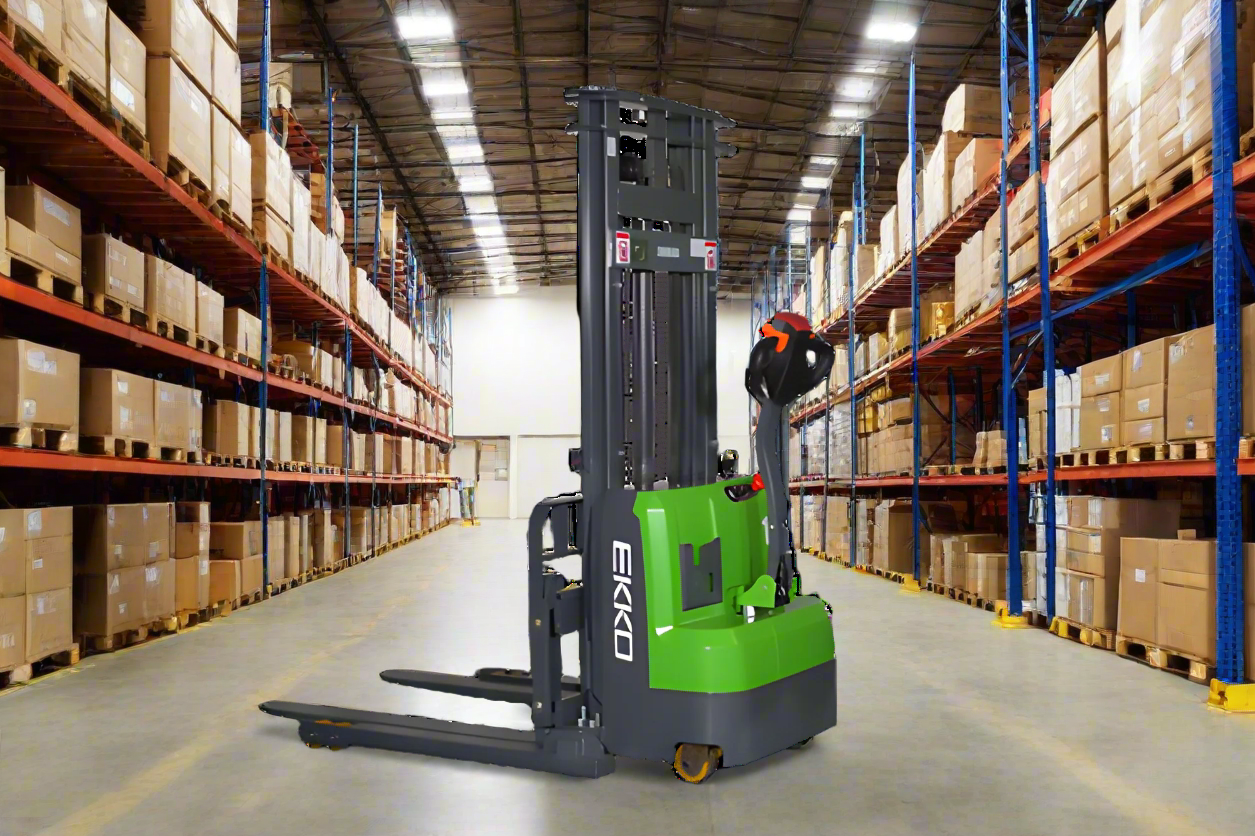 EKKO lithium straddle stacker in a well-organized warehouse with loaded shelves.