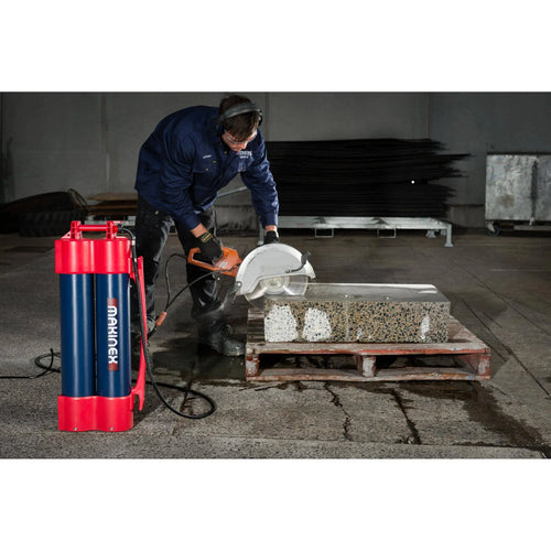 Worker using a saw with a Makinex water unit to cut concrete blocks