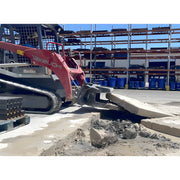 Star Industries 127 construction equipment breaking concrete slab in industrial storage area