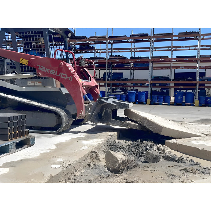 Star Industries 127 construction equipment breaking concrete slab in industrial storage area