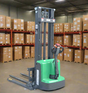 EKKO electric pallet stacker in a warehouse with shelves full of brown boxes in the background