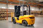 EKKO yellow diesel forklift inside a warehouse with pallet racks and boxes in the background