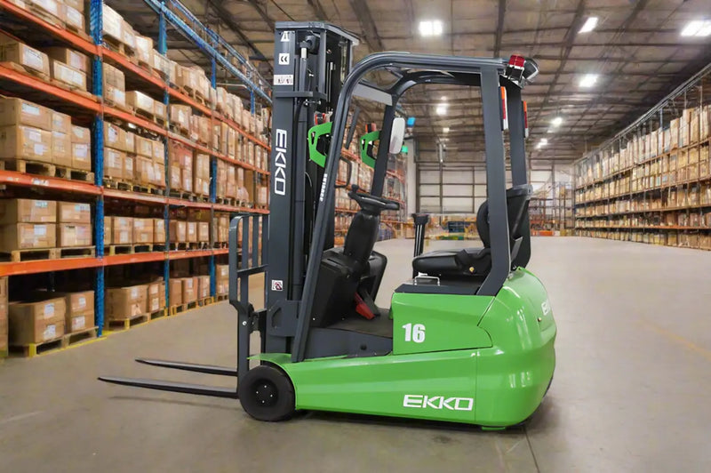 EKKO green Electric Forklift with black forks inside a warehouse with stacked boxes
