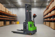 EKKO Electric Pallet Stacker in a warehouse with shelves of boxes on both sides