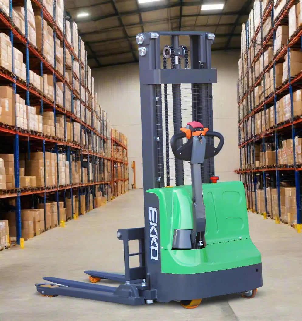 EKKO green Electric Pallet Stacker in warehouse aisle between tall shelves with boxes