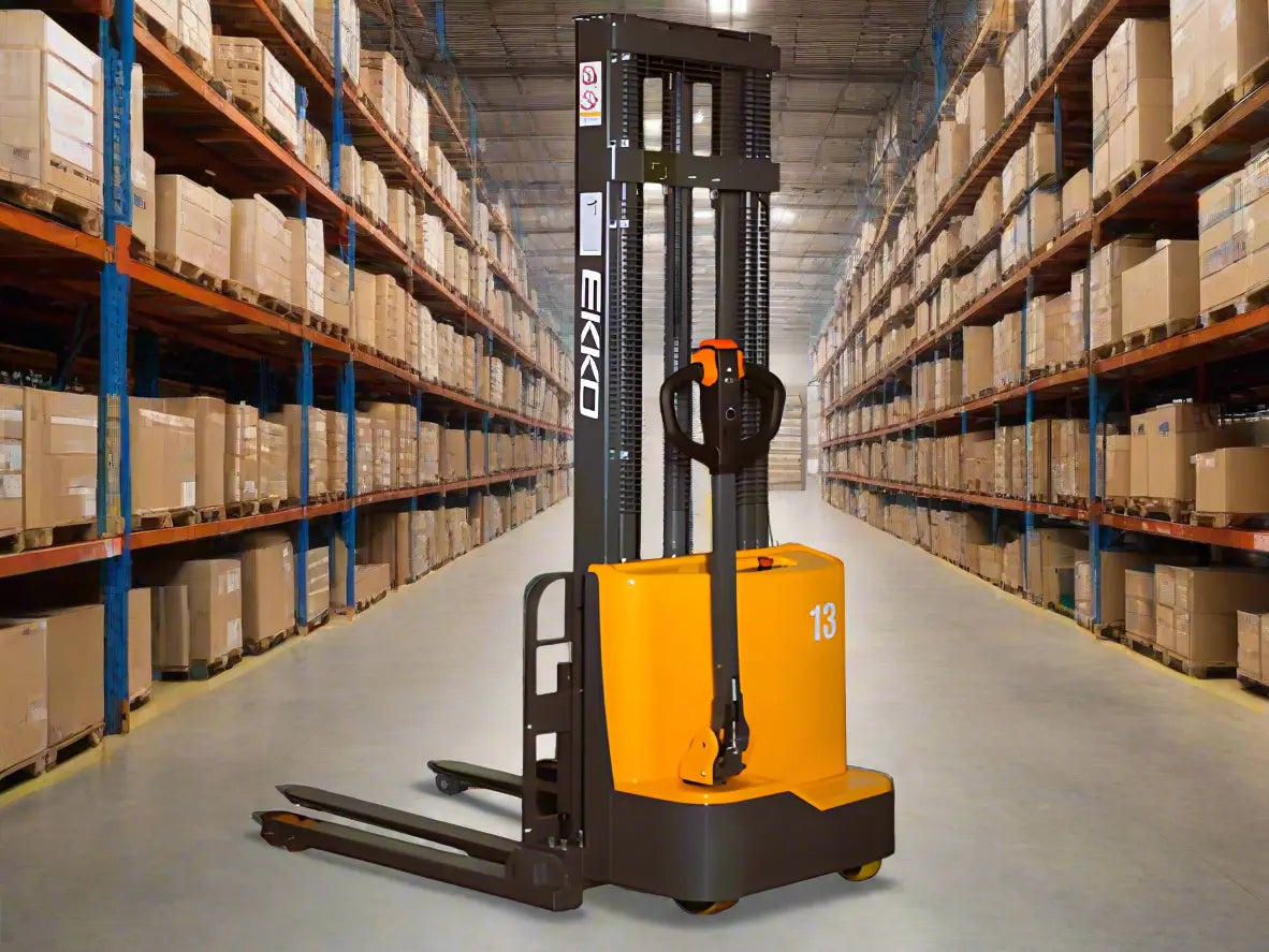 EKKO electric pallet stacker in warehouse aisle with shelves full of boxes on both sides