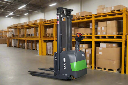 EKKO Electric Pallet Stacker in warehouse with yellow shelving and stacked cardboard boxes