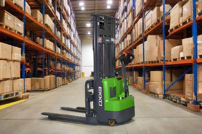 EKKO Electric Pallet Stacker in a warehouse aisle with shelves full of boxes