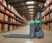 EKKO EP15JLi electric pallet jack in warehouse aisle with shelves of boxes