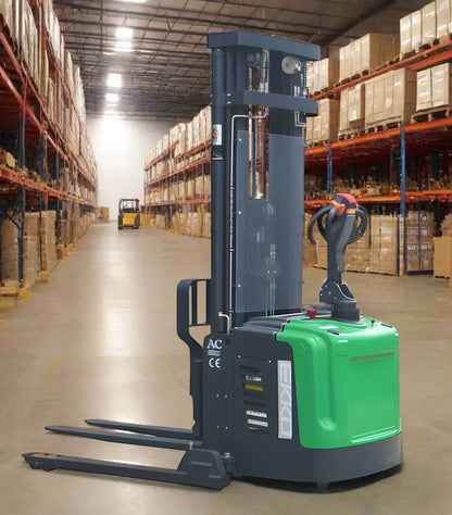 EKKO green and black Electric Pallet Stacker with straddle forks in a large warehouse aisle