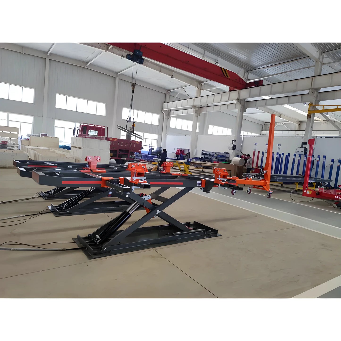 Katool Auto Body Frame Machine with hydraulic lifting system for vehicle repairs in a spacious workshop