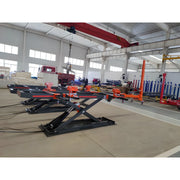 Katool Auto Body Frame Machine with hydraulic lifting system for vehicle repairs in a spacious workshop