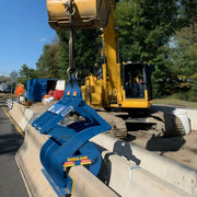 Kenco Concrete Barrier Lift attached to an excavator for efficient concrete barrier handling