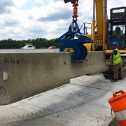Kenco Concrete Barrier Lift in action with a heavy-duty machine moving a concrete barrier on a construction site