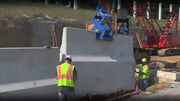 Kenco Concrete Barrier Lift in use at a construction site for moving heavy concrete barriers