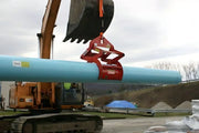 Kenco Concrete Pipe Lift in action lifting a large blue pipe with an excavator on a construction site