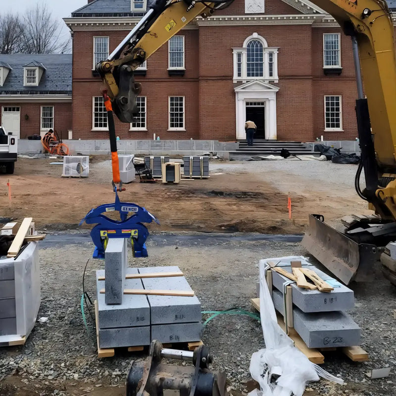 Kenco Curb Lifting Tool in use on a construction site with stack of concrete blocks