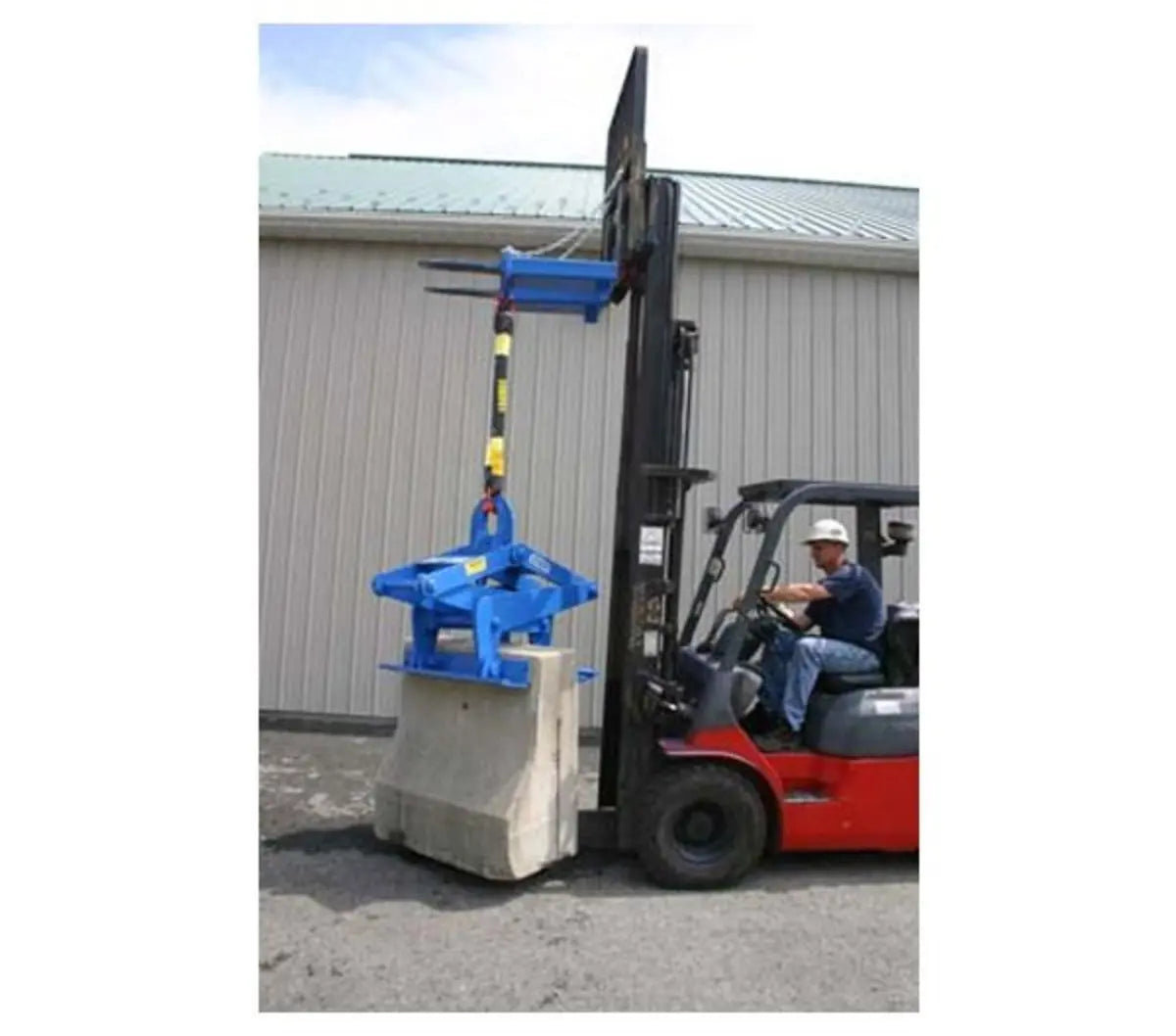 Kenco Forklift Adapter attached to a forklift lifting a concrete block for efficient material handling