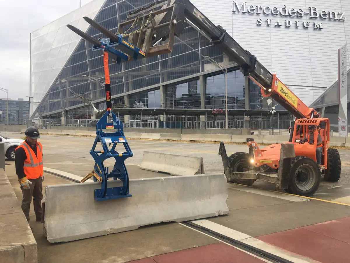 Kenco Forklift Adapter used with a telehandler to lift concrete barriers at Mercedes-Benz Stadium