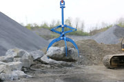 Kenco Hydraulic Rock Grapple in operation, lifting a large boulder at a construction site