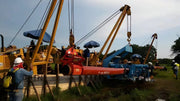 Kenco PL2750 Concrete Pipe Lift in use with cranes and workers on a construction site
