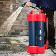 Makinex H2G-14 portable pressure water sprayer with red and blue tank being used outdoors