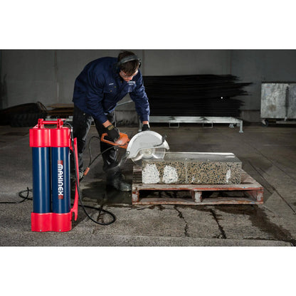 Worker using Makinex H2G-14 core drill machine to cut concrete slab in industrial setting