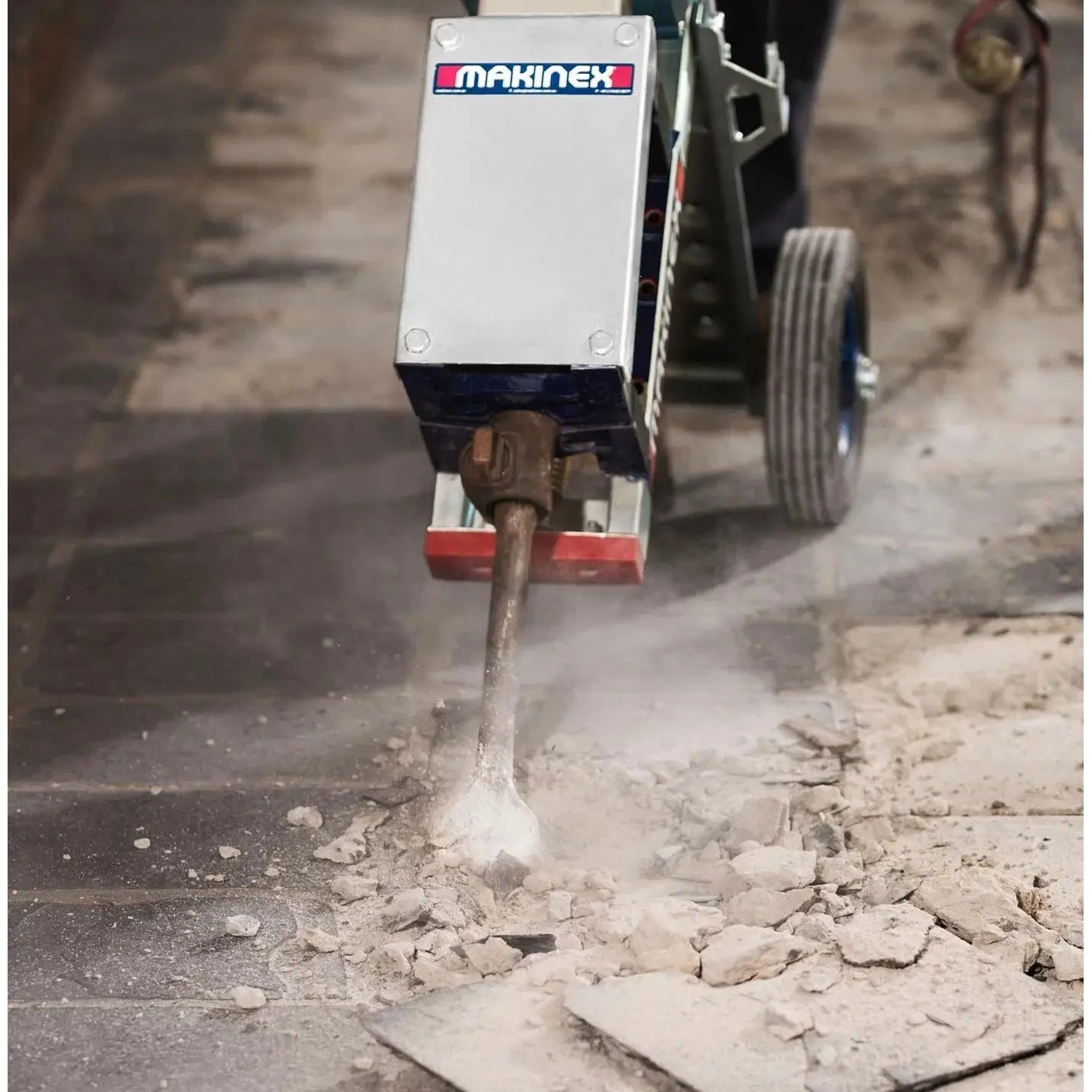 Makinex Jackhammer Trolley in action, effectively breaking concrete with minimal effort