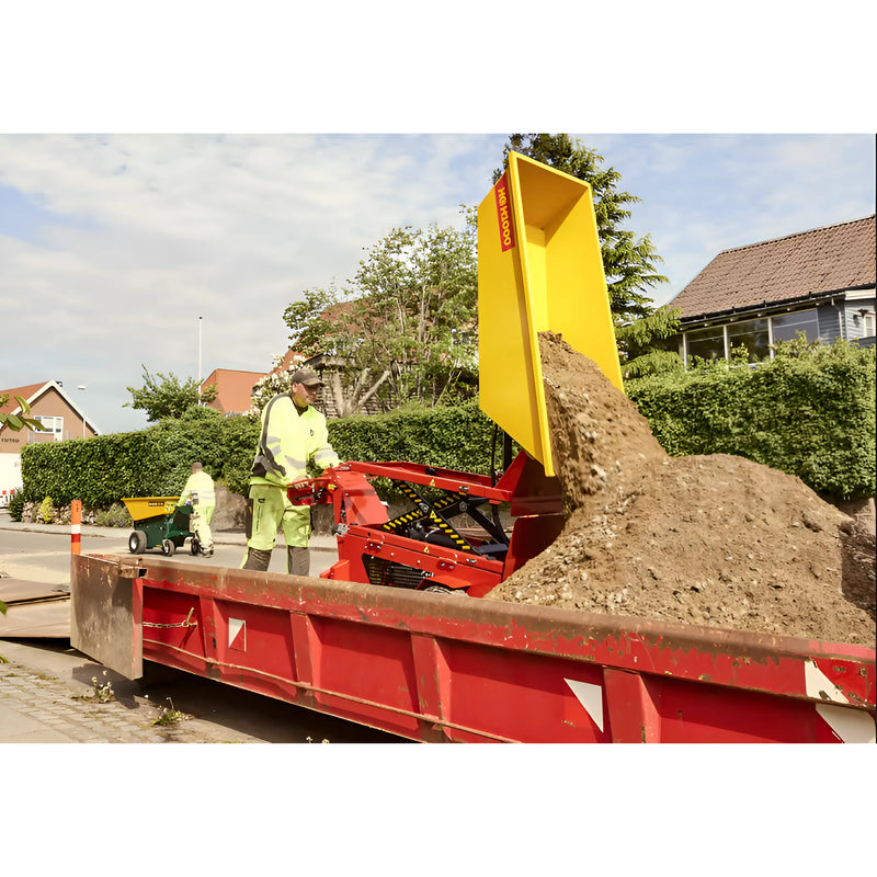 Makinex Mini Dumper in use, unloading dirt at a construction site with workers in safety gear