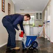 Man using Makinex VS-125-US electric floor scraper machine on tile floor in kitchen