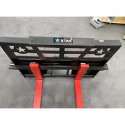 Star Industries 110EC-ITA forklift attachment with black frame and red forks on concrete floor