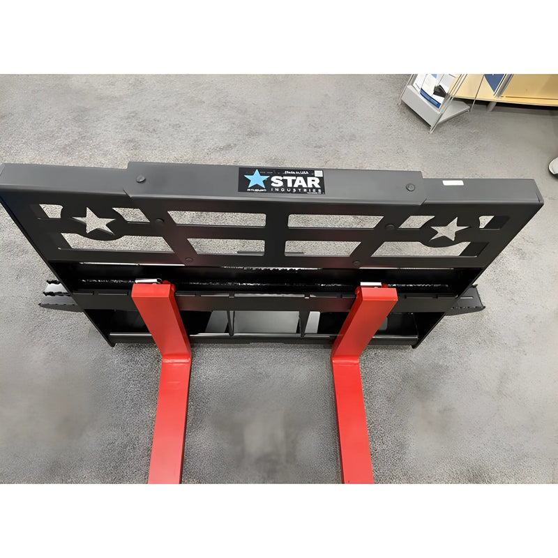 Star Industries 110EC-ITA forklift attachment with black frame and red forks on concrete floor
