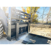 Star Industries 110EC-ITA heavy-duty skid steer pallet forks attachment outdoors with trees in background