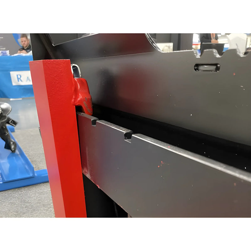 Close-up of red and black metal parts from Star Industries 110EC-ITA equipment showing structural details