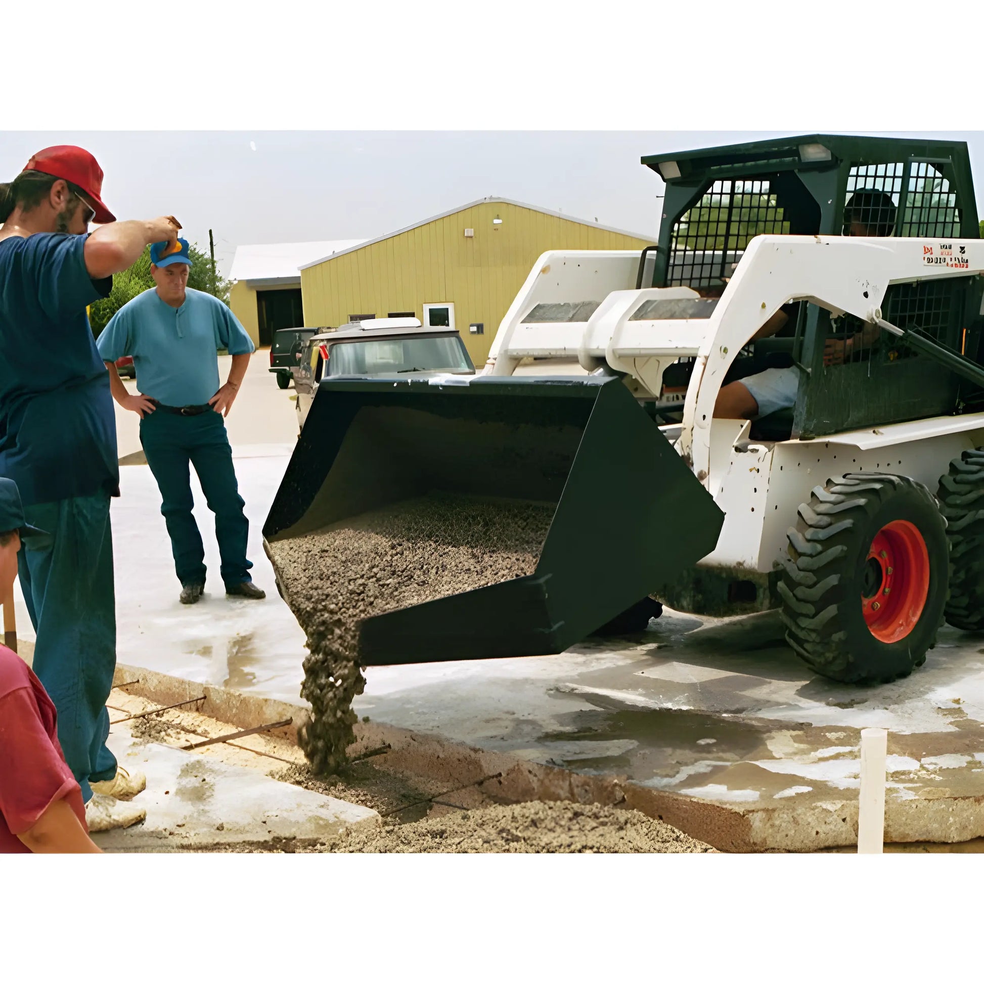 Star Industries 120 125 skid steer loader pouring concrete at construction site with workers supervising
