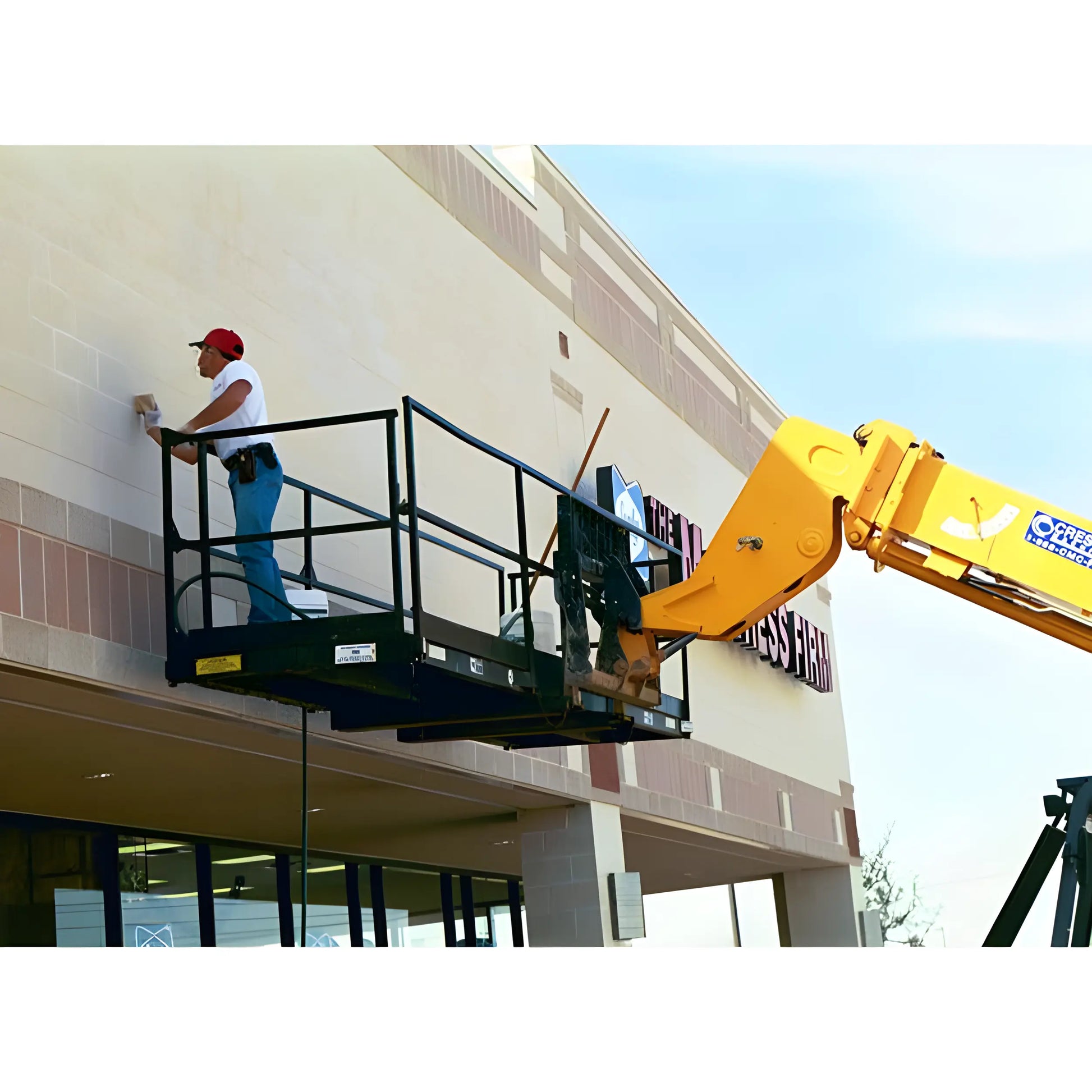 Star Industries 1204C aerial lift with worker cleaning building exterior on elevated platform