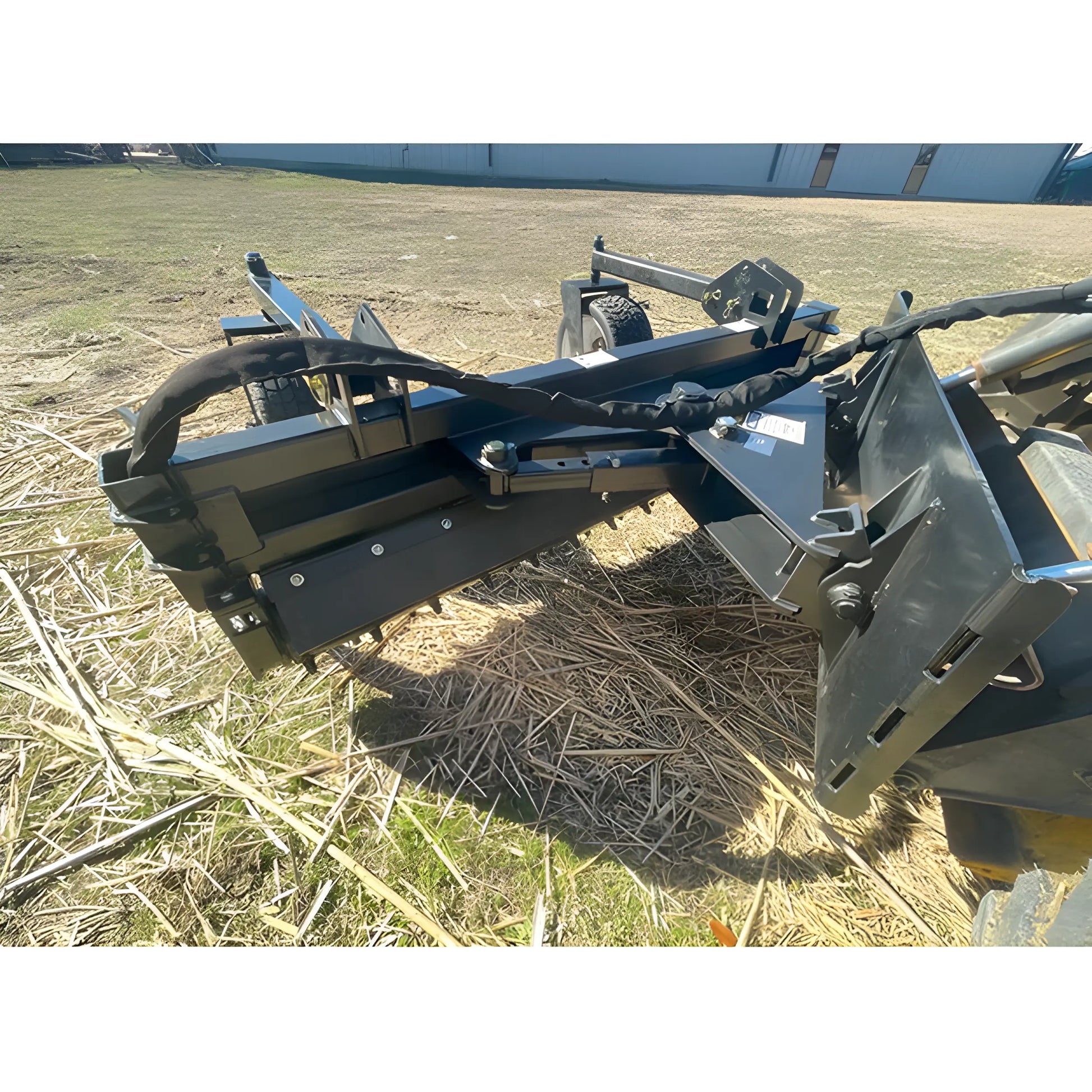 Star Industries 130-72 heavy-duty tractor attachment with metal frame and hydraulic components on field