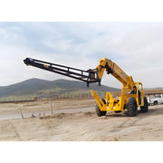 Yellow Star Industries 1325 telescopic handler lifting arm on construction site with hills in background
